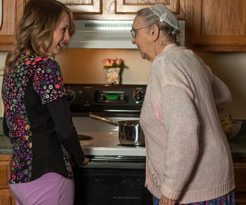 Staff member assisting resident in the kitchen