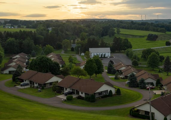 Aerial view of a senior living community with landscaped grounds