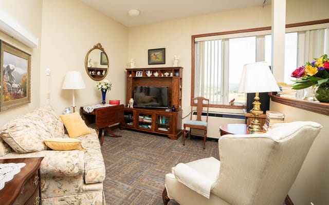 Cozy interior of a resident's room with a sofa and TV
