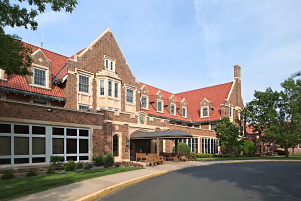 Exterior view of a senior living facility with a porte-cochère