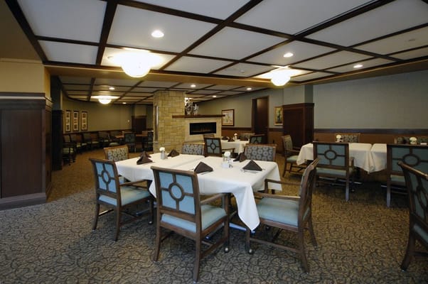Dining area with tables and chairs set for residents