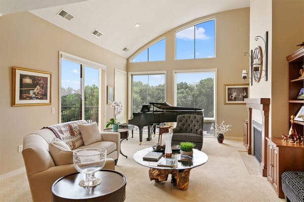 Bright common area with a piano and large windows