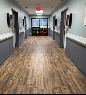Interior hallway with wooden flooring and doorways