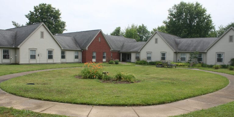Outdoor view of a senior living facility with a garden
