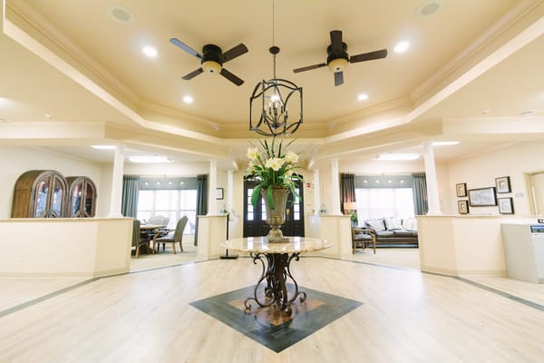 Interior common area with a decorative table and ceiling fans