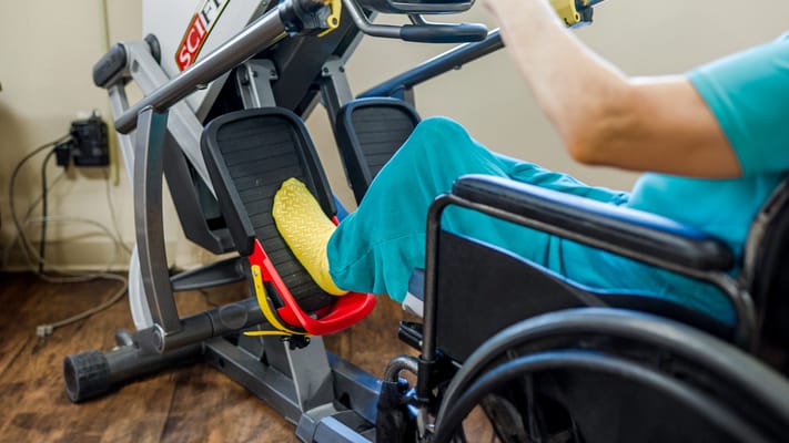 Resident exercising on therapy equipment in a facility
