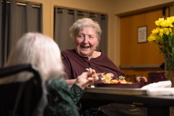 Residents enjoying a meal together in a dining area