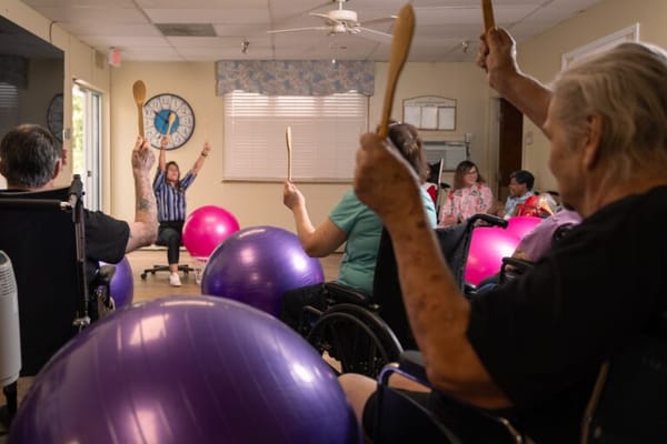 Residents participating in an exercise class with exercise balls