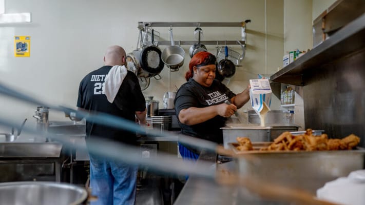 Kitchen staff preparing meals in a busy kitchen