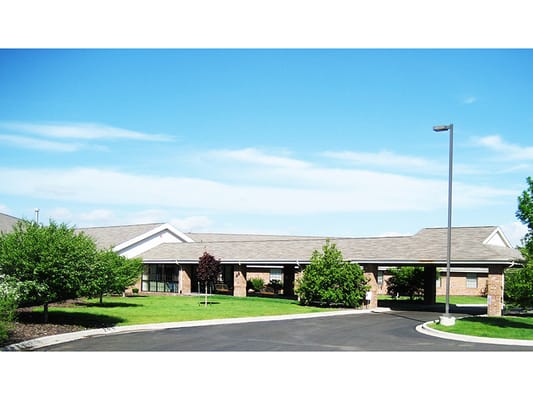 Exterior view of Brookside Inn with green landscaping