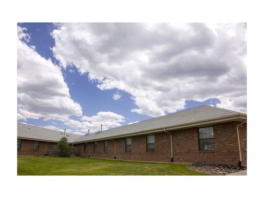 Exterior view of a senior living facility under a cloudy sky