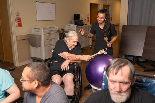 Residents participating in a recreational activity with staff