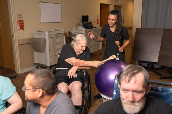 Residents participating in a recreational activity with staff