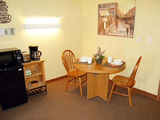 Cozy kitchenette area with a dining table and chairs