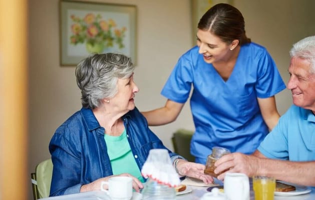 Care staff interacting with a resident during mealtime