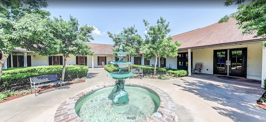 Courtyard with a fountain and greenery