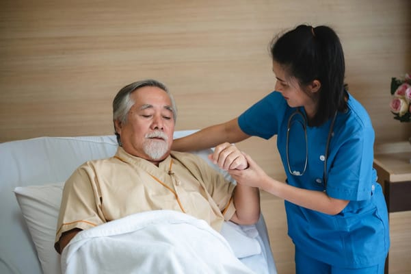 A caregiver assisting a senior resident in a warm setting