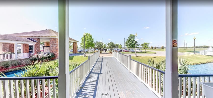 View of a walkway leading to a facility with greenery