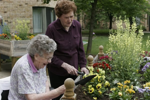 Residents gardening in a vibrant outdoor area