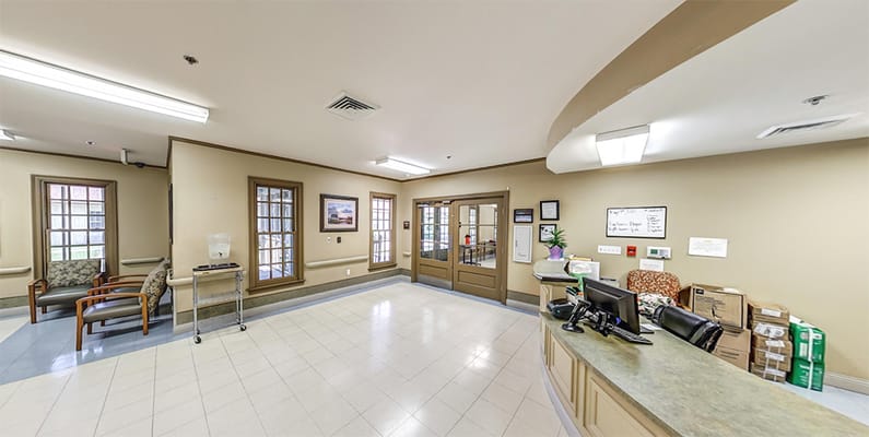 Lobby area of a senior living facility with reception desk