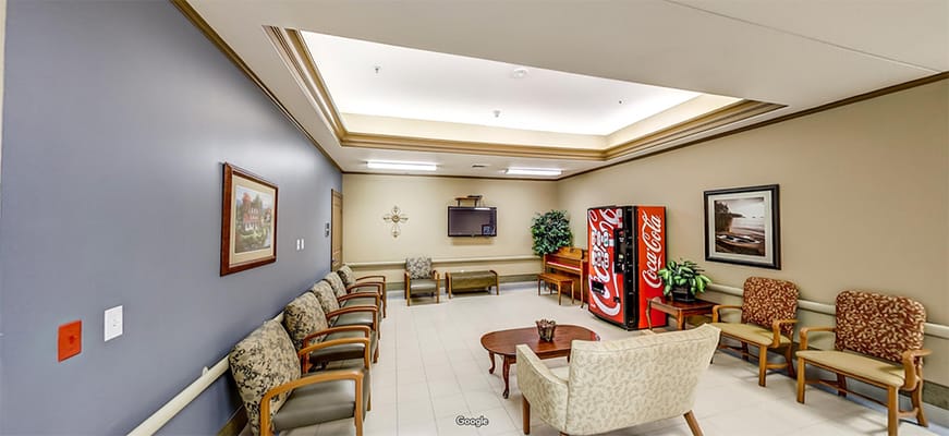 A cozy common area with seating and a vending machine