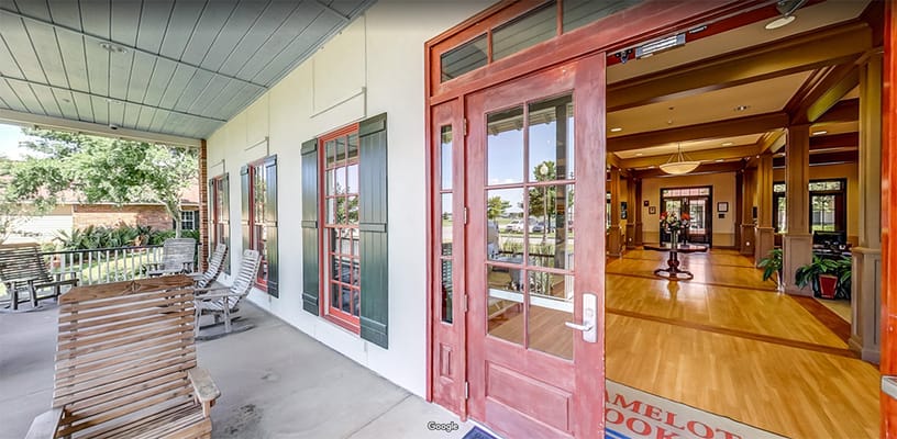 Entrance view of a senior living facility with seating area