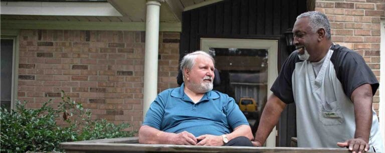 Staff member chatting with a resident outdoors