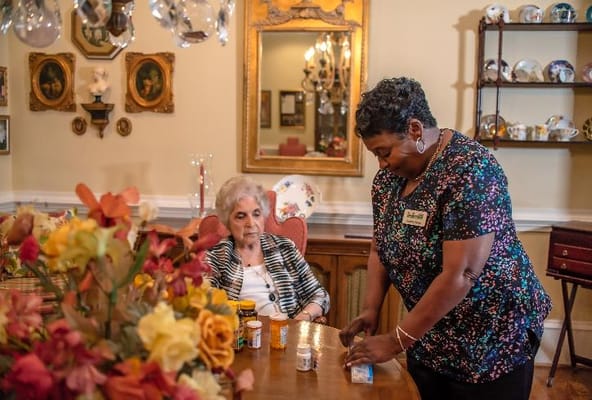 Staff assisting a resident in a common area