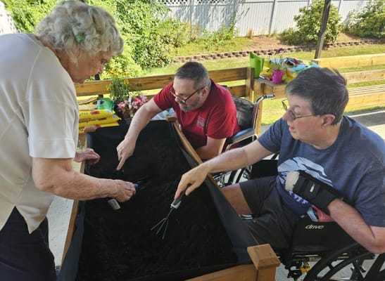 Residents engaging in gardening activity outdoors