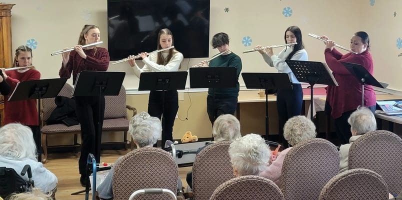 Residents enjoying a live music performance by young musicians