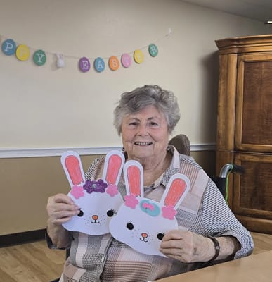 Resident holding Easter crafts in a common area