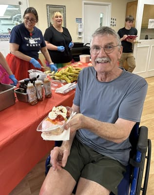 Resident enjoying a dessert during an activity event.