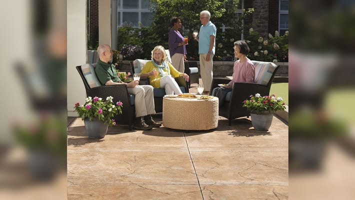 Residents enjoying snacks and drinks in a garden area