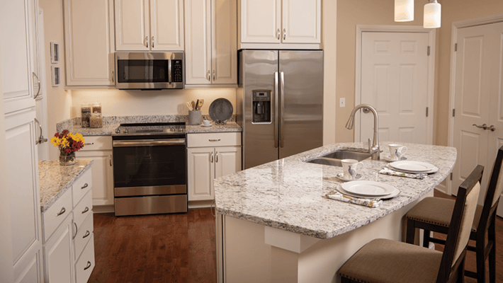 Bright, modern kitchen with granite countertop and appliances