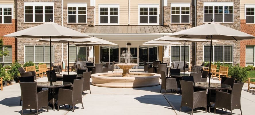 Outdoor patio area with seating and fountain