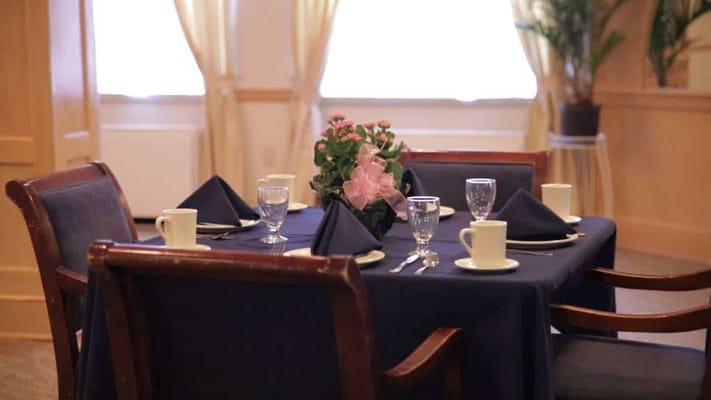 Elegantly set dining table with flowers