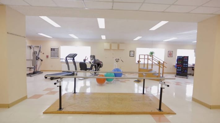 Interior view of a rehabilitation area with gym equipment