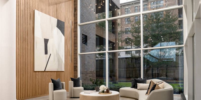 A modern interior lobby with large windows and art