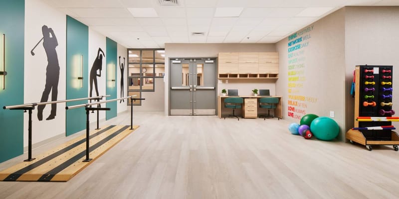 Therapy room with exercise equipment and wall art