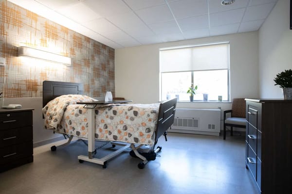 Private resident room with hospital bed and decor
