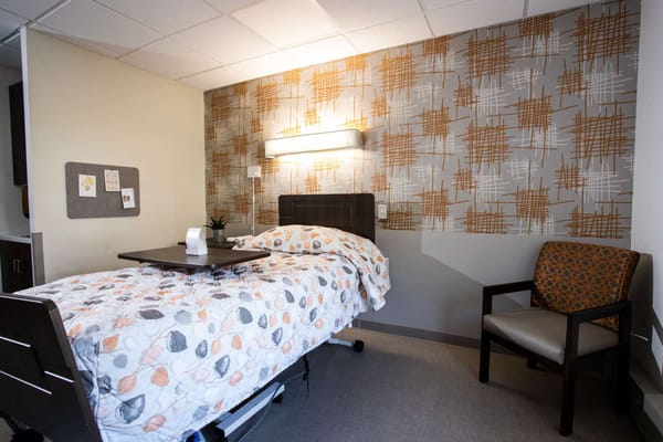 Cozy resident room with a bed and chair