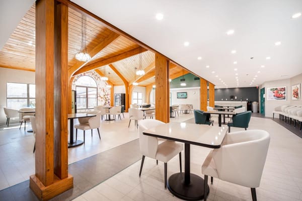 Bright dining area with modern furniture and wood beams
