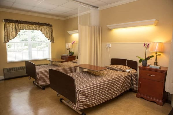 Private resident room with two beds and natural light
