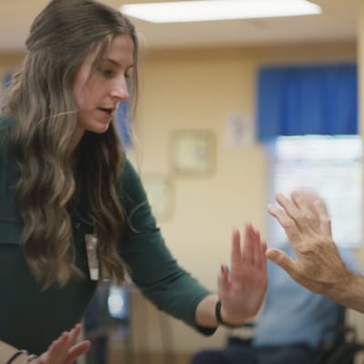 Resident and staff member engaging in an activity