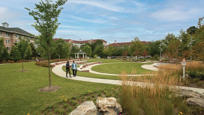 Residents walking in a landscaped outdoor area