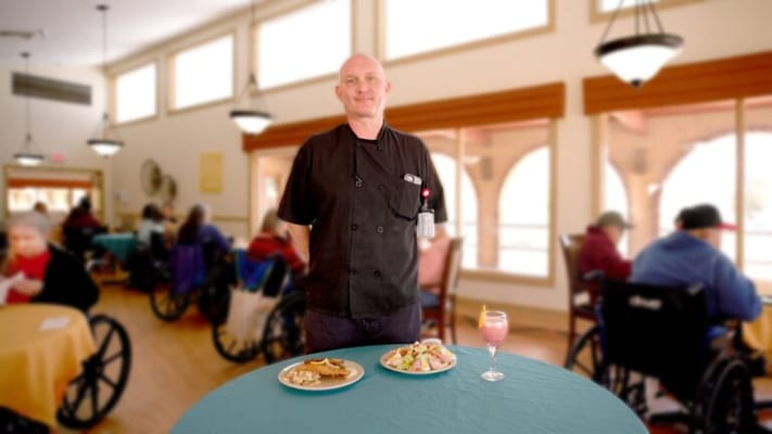 Chef presenting a meal in the dining room