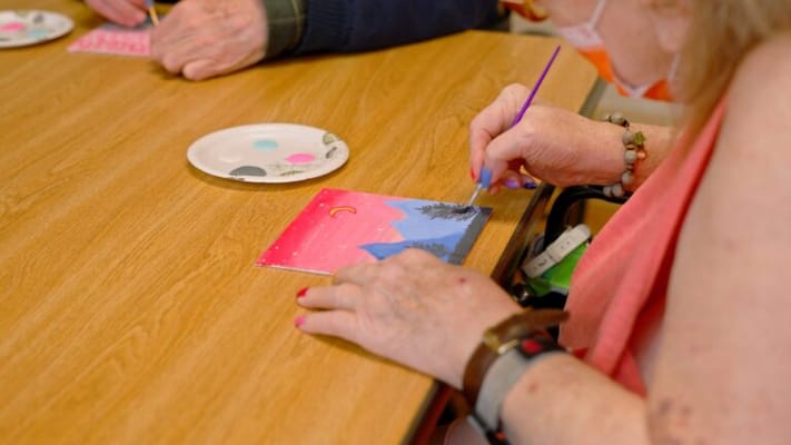 Resident painting during an art activity session