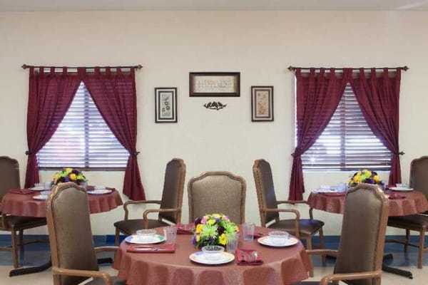 Bright dining area with set tables and floral centerpieces