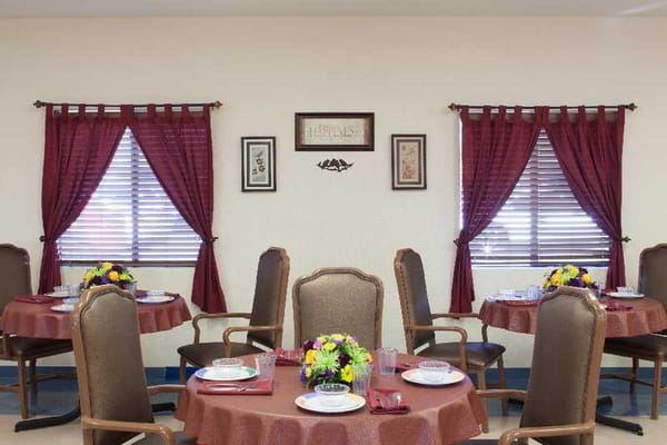 Bright dining area with set tables and floral centerpieces