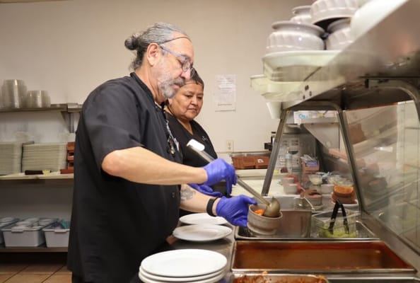 Staff serving food in the dining area